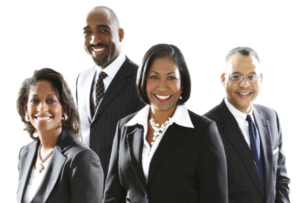 four smiling individuals in suits